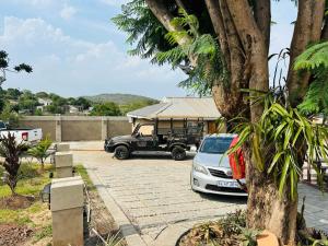 a truck parked in a parking lot with a house at Siyaya Palace in Jozini