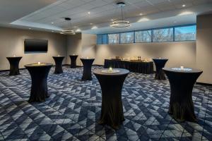 a room with black stools in a room with a tv at Courtyard by Marriott New Haven Wallingford in Wallingford
