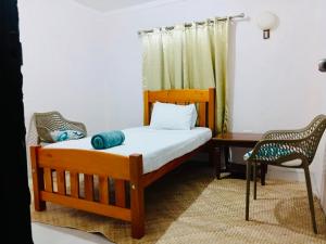 a bedroom with a bed and a desk and a chair at Muaitale House in Suva
