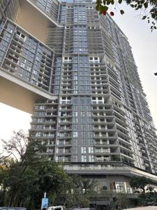 a tall apartment building with a lot of windows at Măng Homestay in Kim Quan