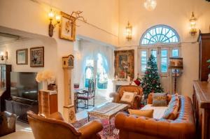 a living room with a christmas tree and a couch at Home Tower tree เชียงใหม่ in Pong Yaeng
