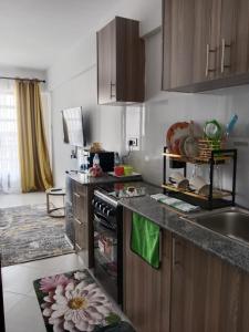 a kitchen with a sink and a stove top oven at Relax Crib Nairobi in Nairobi