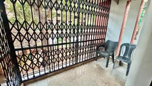 a balcony with a black fence and a chair at Muffys Baga Apartment in Baga
