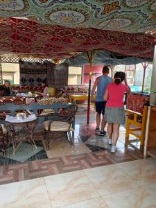 a group of people walking around a restaurant at Bob Marley Peace hotel luxor in Luxor