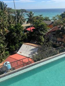 a view of a swimming pool and the ocean at Cielo Hiriketiya in Hiriketiya