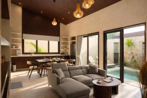 a living room with a couch and a table at Eden Villas Lombok in Kuta Lombok +21 photos
