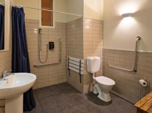 a bathroom with a toilet and a sink at Naseby Apartments in Naseby +34 photos