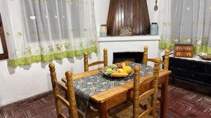 a dining room table with a bowl of fruit on it at La Guevarina- Casa de Campo in Tres Esquinas
