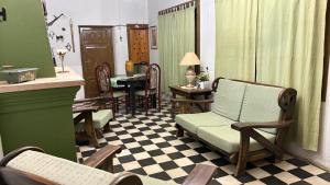 an old living room with chairs and a table at La Guevarina- Casa de Campo in Tres Esquinas