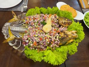 a salad with fish and rice on a plate at Even Beach Resort in Wayikkal