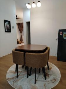 a wooden table and chairs in a room at Risfeena Home in Sekinchan