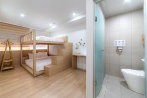 a small room with a bunk bed and a bathroom at Hi Seoul Hostel Central in Seoul +124 photos