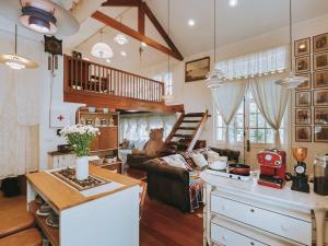 a kitchen and living room with a couch and a table at Home Tower tree เชียงใหม่ in Pong Yaeng