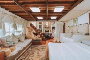 a living room with teddy bears sitting on a couch at Home Tower tree เชียงใหม่ in Pong Yaeng