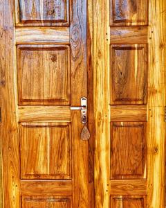 an old wooden door with a lock on it at Amani Beach House, Ushongo in Pangani