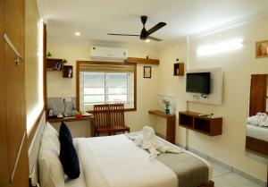 a hotel room with a bed and a tv at Cloud9 Airport Hotel in Nedumbassery