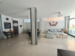 a living room with a couch and a table at YP Hostel in Ban Nai Na