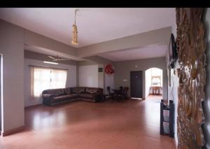 a large living room with a couch and a table at Tapovan Fruitopia in Sultan Bathery