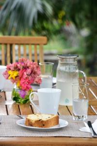 a table with a plate of bread and a jar of water at Les Jardins d'Ostréa in Port Maturin