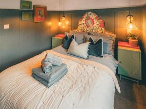 a bedroom with a large bed with towels on it at The Herdsman - Uk50615 in Sabden