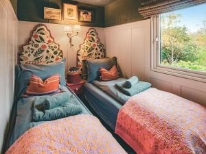 a small room with two beds and a window at The Herdsman - Uk50615 in Sabden +5 photos