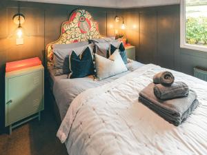 a bedroom with a large bed with a large headboard at The Herdsman - Uk50615 in Sabden