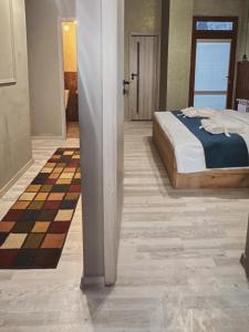 a bedroom with a bed and a checkerboard floor at Valley Park Dilijan in Dilijan
