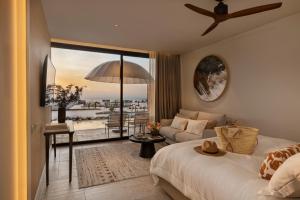 a bedroom with a bed and a living room with a view at Gordonia Zikhron Ya'akov in Zikhron Ya'akov