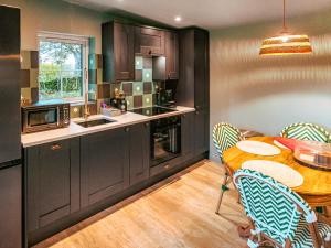 a kitchen and dining room with a table and chairs at The Twitcher - Uk50612 in Sabden