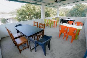 a group of tables and chairs on a patio at Aashray Guestroom in Murud