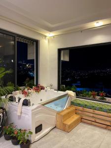 a bath tub with a view of a city at Residence Gratia by Eagle View in Kigali