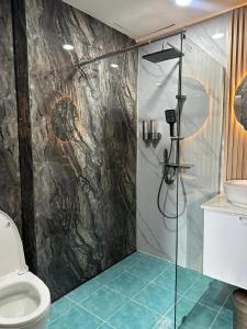 a bathroom with a shower and a toilet at Puttaya Glow in Pattaya +27 photos