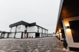a row of buildings on a brick road at AURA hotel in Taraz