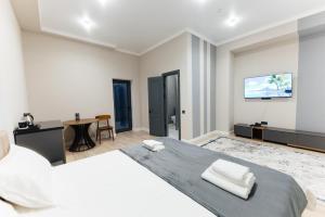 a bedroom with a large bed and a table at AURA hotel in Taraz