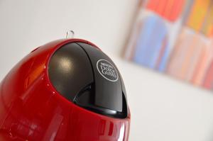 a red computer mouse sitting on top of a table at Alojamiento Santa Rosa in Madrid