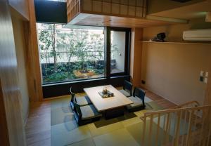 a dining room with a table and a window at NEW2025! Shirakaba ROKUI 白樺 緑居 Architect-designed Luxury Villa with Concierge Service in Osaka