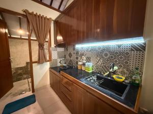 a kitchen with a sink and a counter top at Lonovilla Menoreh Yogyakarta in Junggrangan