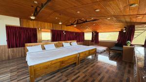 a bedroom with a large wooden bed in a room at 11 Haven Street Kodaikanal in Kodaikānāl