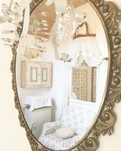 a mirror with a chair in a room at Spello House Dormio in Spello