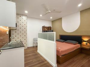 a small bedroom with a bed and a kitchen at Hoang Long Son 2 in Ho Chi Minh City