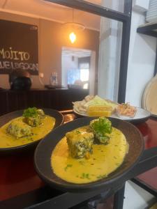 two plates of food on a counter in a restaurant at Ella Ceylon Homies Hostel in Ella +65 photos