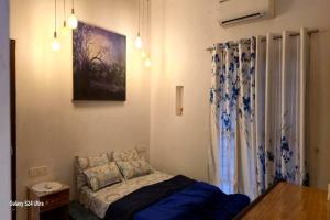 a small bedroom with a bed and a window at Sea Zars pool villa in Cochin +13 photos