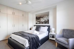 a bedroom with a bed and a chair at Ocean Grove Beach House 2 - Pets - Late checkout - Accessible in Ocean Grove