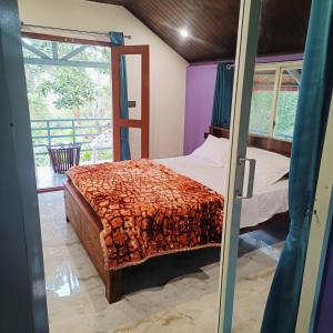 a bedroom with a bed and a window at Golden Valley Abode in Siddapur +8 photos