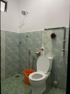 a bathroom with a toilet and a shower at Homestay Anjang in Tapah