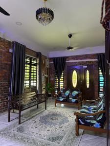 a living room with benches and a brick wall at Homestay Anjang in Tapah
