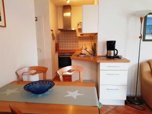 a small kitchen with a table with stars on it at Fewo 1 im Fischerhaus mit Wintergarten und Terrasse in Seedorf +91 photos