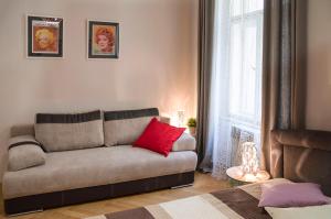 a living room with a couch and a red pillow at Modern Apartment Zlatnicka 8 in Prague