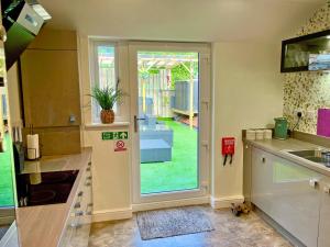 a kitchen with a door leading to a yard at Station View in Pickering