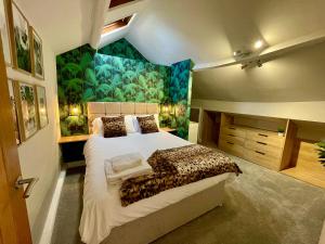 a bedroom with a large bed with a mural at Station View in Pickering
